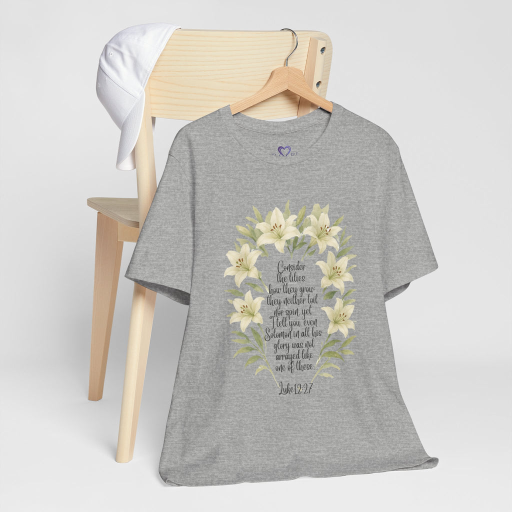 “Watercolor lily Christian t-shirt featuring Luke 12:27. A soft, faith-inspired reminder to trust God’s care. Beautiful gift for women of faith, Bible study, or everyday encouragement.”