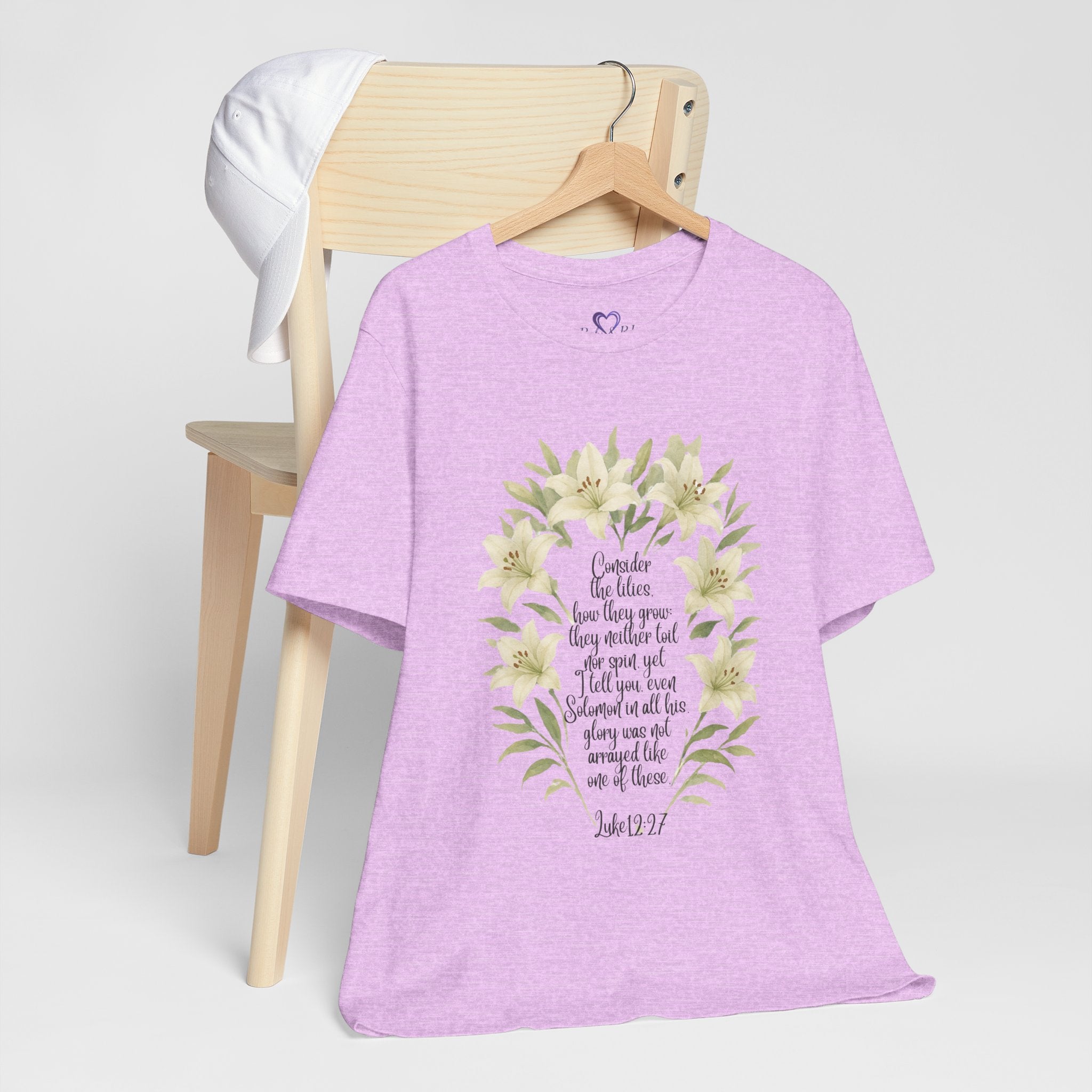 “Watercolor lily Christian t-shirt featuring Luke 12:27. A soft, faith-inspired reminder to trust God’s care. Beautiful gift for women of faith, Bible study, or everyday encouragement.”