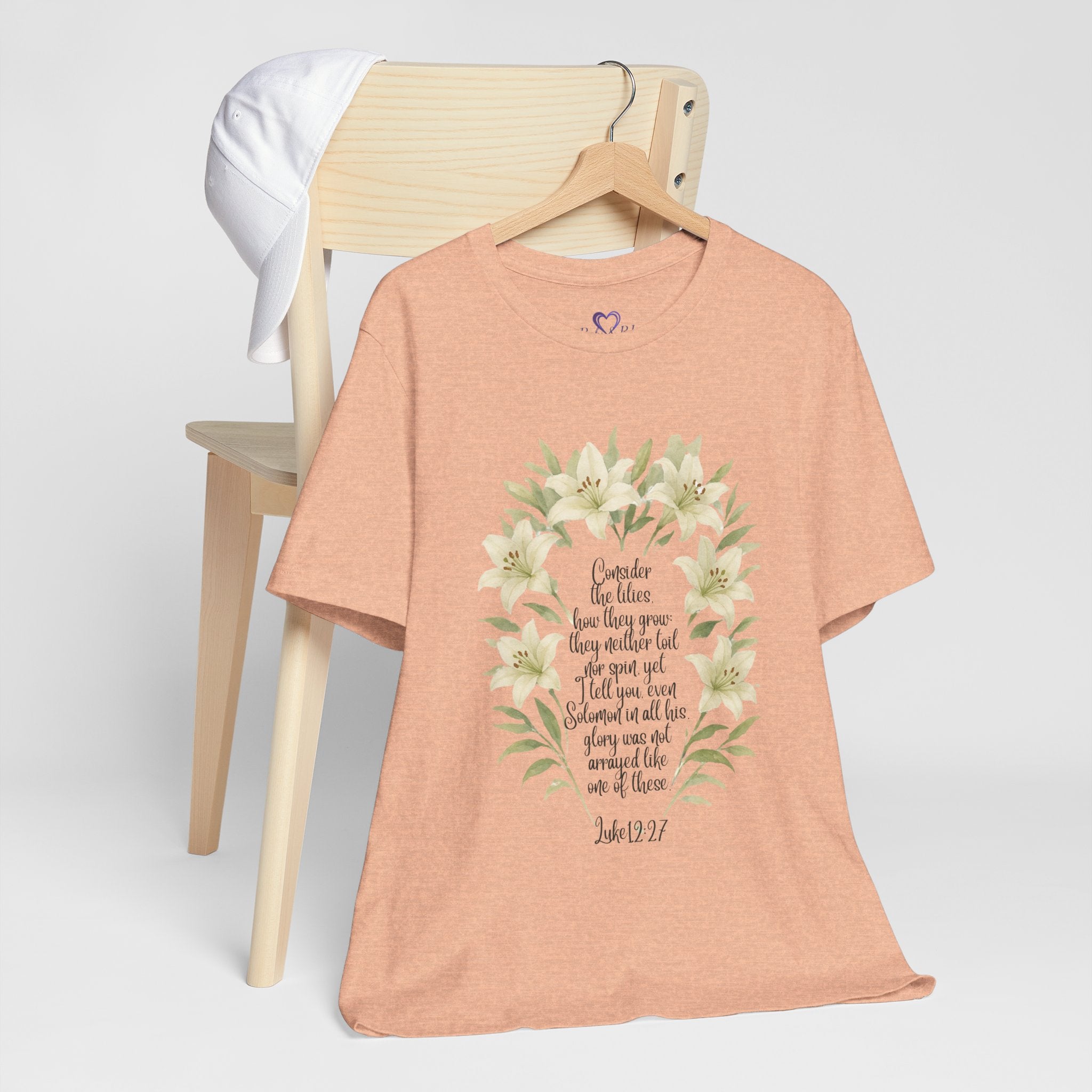 “Watercolor lily Christian t-shirt featuring Luke 12:27. A soft, faith-inspired reminder to trust God’s care. Beautiful gift for women of faith, Bible study, or everyday encouragement.”