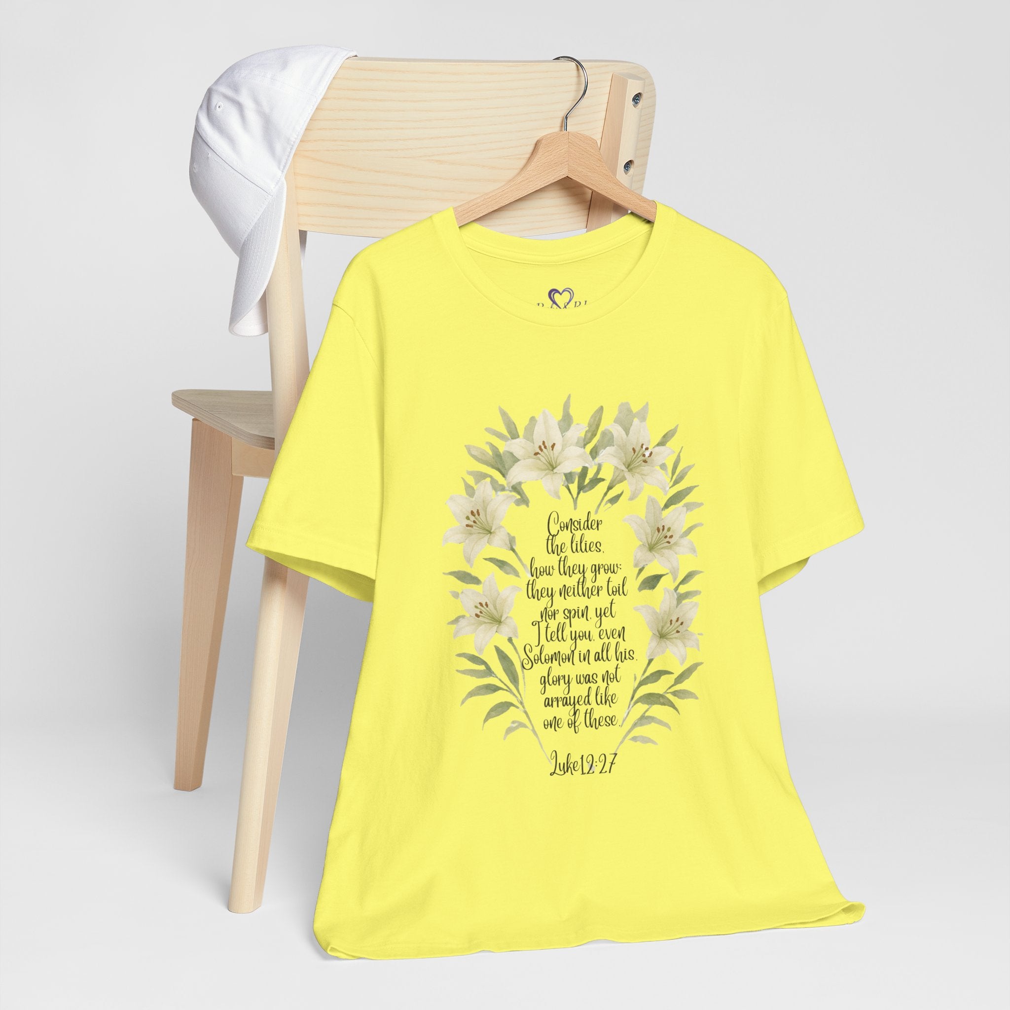 “Watercolor lily Christian t-shirt featuring Luke 12:27. A soft, faith-inspired reminder to trust God’s care. Beautiful gift for women of faith, Bible study, or everyday encouragement.”