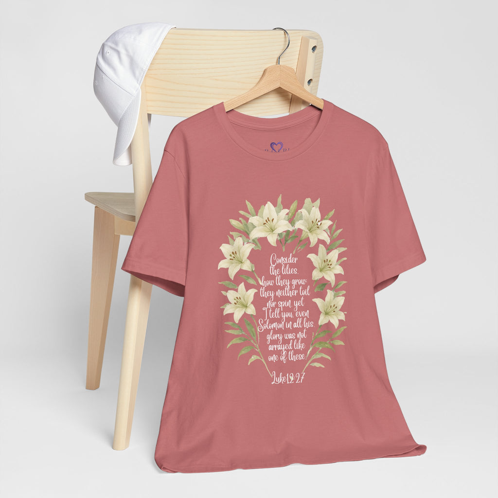 “Watercolor lily Christian t-shirt featuring Luke 12:27. A soft, faith-inspired reminder to trust God’s care. Beautiful gift for women of faith, Bible study, or everyday encouragement.”