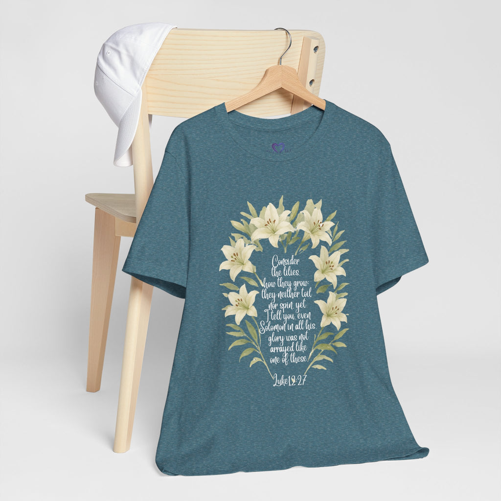 “Watercolor lily Christian t-shirt featuring Luke 12:27. A soft, faith-inspired reminder to trust God’s care. Beautiful gift for women of faith, Bible study, or everyday encouragement.”