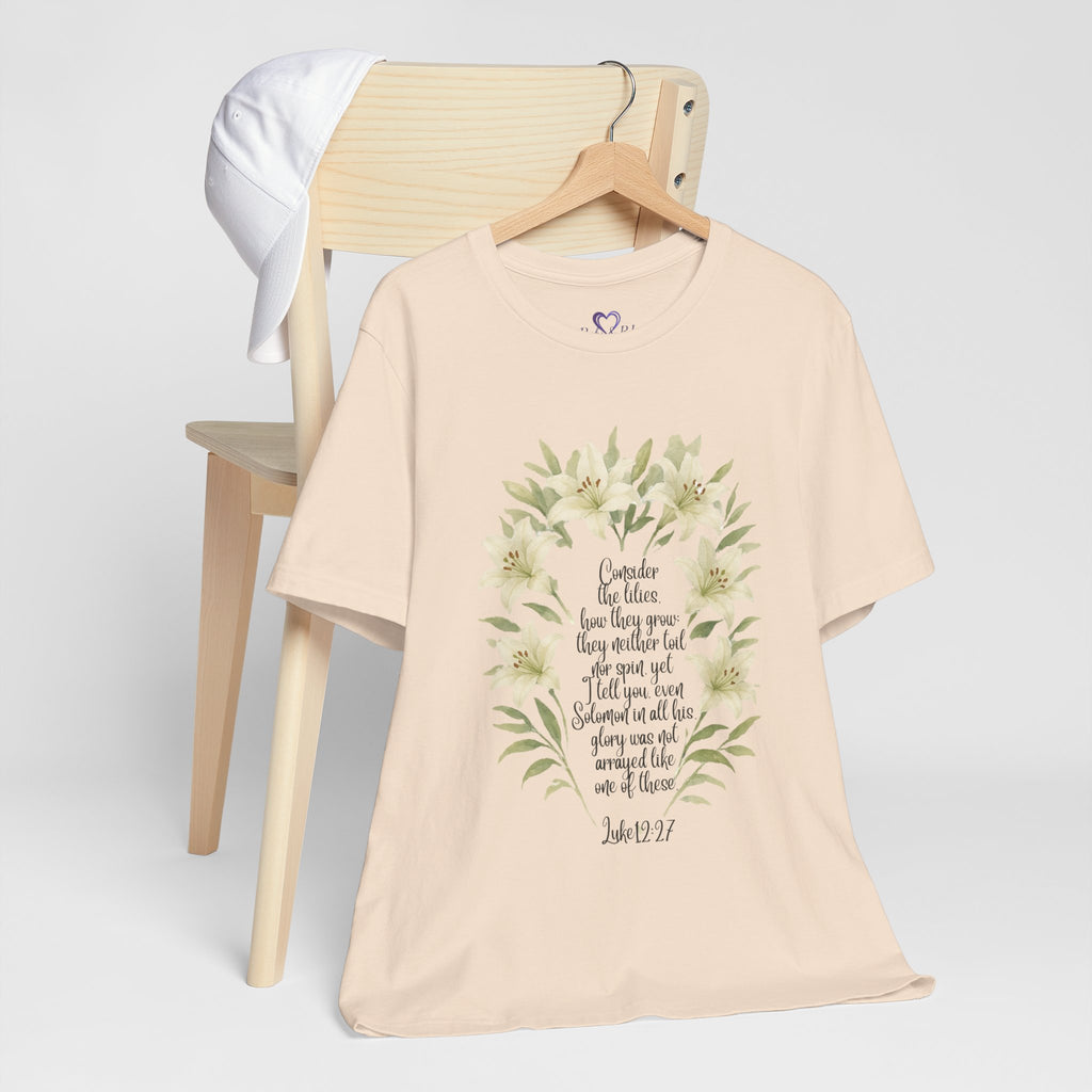 “Watercolor lily Christian t-shirt featuring Luke 12:27. A soft, faith-inspired reminder to trust God’s care. Beautiful gift for women of faith, Bible study, or everyday encouragement.”